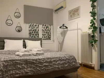 a bedroom with a bed with two towels on it at Charming House in Central Athens in Athens