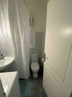 a bathroom with a white toilet and a sink at Charming House in Central Athens in Athens