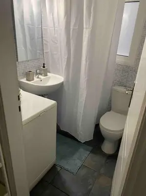 a bathroom with a toilet and a sink at Charming House in Central Athens in Athens