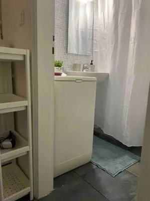 a white bathroom with a sink and a shower at Charming House in Central Athens in Athens