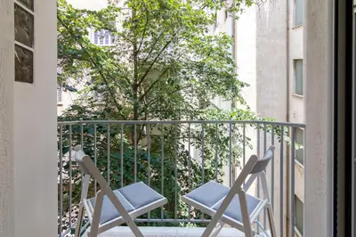 two chairs on a balcony with a tree at Exclusive Studio in Athens A in Athens