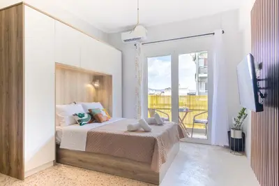 a bedroom with a bed and a balcony at Vivid Stays Athens in Athens
