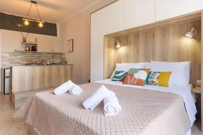 a bedroom with two beds with towels on them at Vivid Stays Athens in Athens