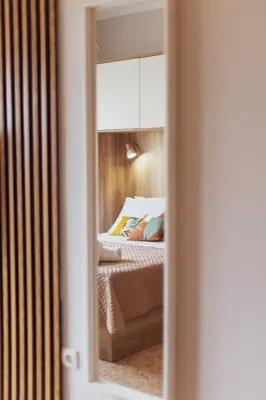 a bedroom with a bed and a mirror at Vivid Stays Athens in Athens