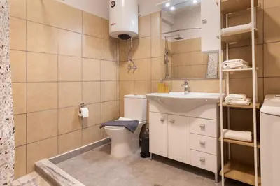 a small bathroom with a toilet and a sink at Vivid Stays Athens in Athens