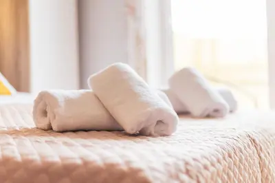a couple of towels sitting on a bed at Vivid Stays Athens in Athens