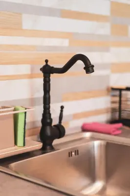 a kitchen sink with a black kitchen faucet at Vivid Stays Athens in Athens