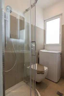 a bathroom with a shower and a toilet and a window at Elegant Studio In Athens B in Athens