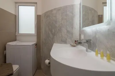 a bathroom with a sink and a toilet and a mirror at Elegant Studio In Athens B in Athens