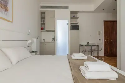 a bedroom with a white bed with towels on it at Elegant Studio In Athens B in Athens
