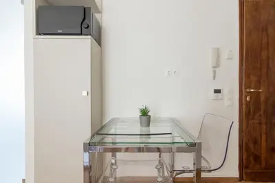 a glass table with a potted plant on top of it at Elegant Studio In Athens B in Athens