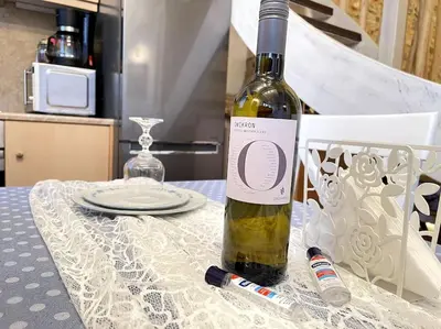 a bottle of wine sitting on top of a table at LIVING IN A CAVE UNDER ACROPOLIS in Athens