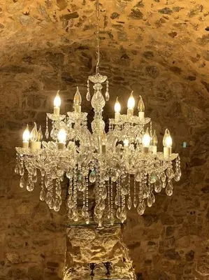 a chandelier hanging from a ceiling in a room at LIVING IN A CAVE UNDER ACROPOLIS in Athens
