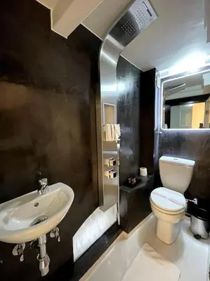 a bathroom with a sink and a toilet at LIVING IN A CAVE UNDER ACROPOLIS in Athens
