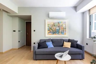 a living room with a couch and a table at Bright 2BDR Apartment Downtown Exarcheia! in Athens