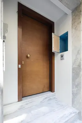 a wooden door in a room with a wall at Bright 2BDR Apartment Downtown Exarcheia! in Athens