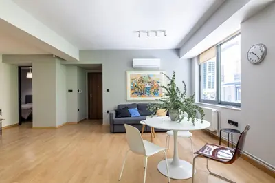 a living room with a table and a couch at Bright 2BDR Apartment Downtown Exarcheia! in Athens