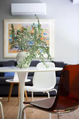 a white table with a potted plant on top of it at Bright 2BDR Apartment Downtown Exarcheia! in Athens