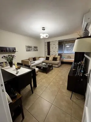 a living room with a couch and a table at Hill View Apartment near Acropolis in Athens