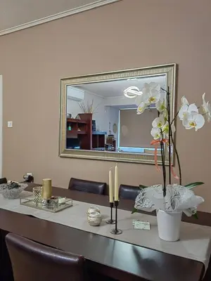 a table with a mirror and two candles on it at Hill View Apartment near Acropolis in Athens