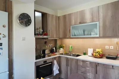 a kitchen with a sink and a clock on the wall at Hill View Apartment near Acropolis in Athens