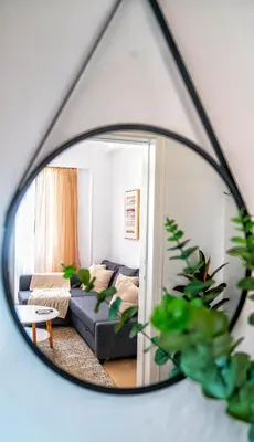 a living room with a couch and a mirror at Lux Garden Apartment near Acropolis in the heart of Athens in Athens