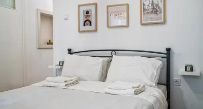 a bedroom with a bed with towels on it at Lux Garden Apartment near Acropolis in the heart of Athens in Athens