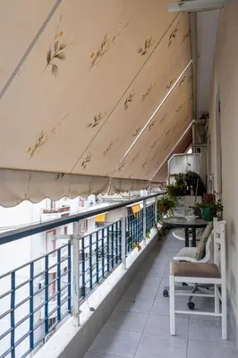a balcony with a table and a chair at Attiki - Appartment in Athens