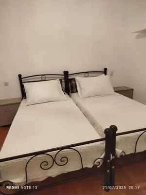 two beds sitting next to each other in a bedroom at Attiki - Appartment in Athens