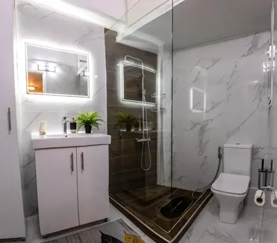 a bathroom with a shower and a toilet and a sink at Attiki - Appartment in Athens