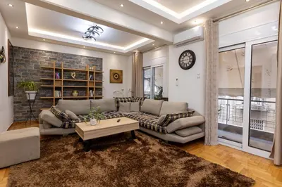 a living room with a couch and a table at Attiki - Appartment in Athens