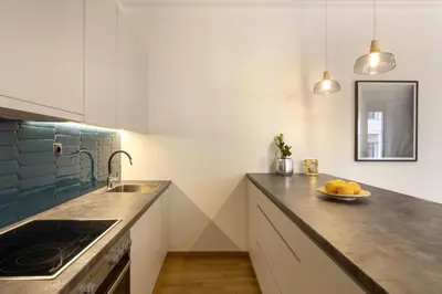 a kitchen with a sink and a counter top at Versi2- Stylish 1BR pays homage to timeless charm in Athens