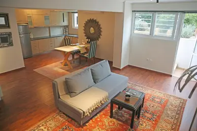 a living room with a couch and a table at Sunset Sea Mini Studio Anavissos in Anavissos