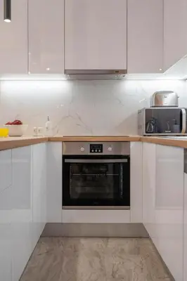 a kitchen with white cabinets and an oven at LIV - Modern Flat in Kolonaki in Athens