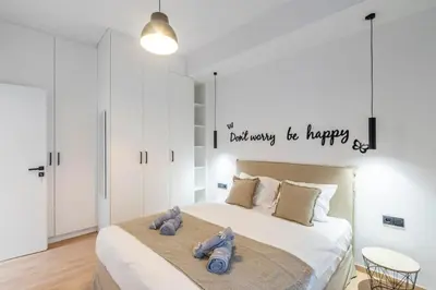 a bedroom with a bed with two stuffed animals on it at LIV - Modern Flat in Kolonaki in Athens
