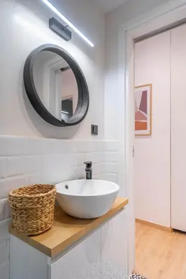 a bathroom with a white sink and a mirror at LIV - Modern Flat in Kolonaki in Athens