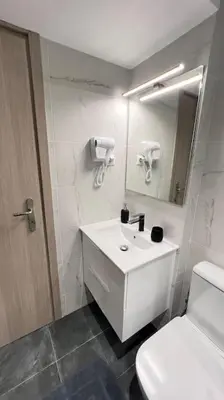 a bathroom with a sink and a toilet and a mirror at FlatG 23 in Athens