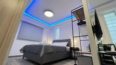 a bedroom with a bed with a blue ceiling at FlatG 23 in Athens
