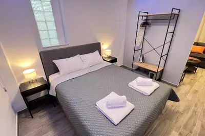 a bedroom with a bed with two towels on it at FlatG 23 in Athens