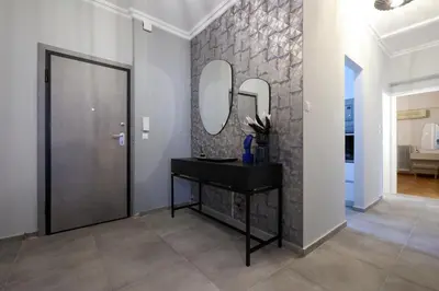 a hallway with a mirror and a black console table at Prime location Athens Exec 2BD Apt by Live&Travel in Athens