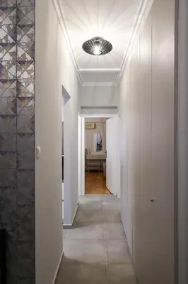a hallway with white walls and a ceiling at Prime location Athens Exec 2BD Apt by Live&Travel in Athens