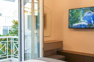 a bedroom with a tv and a window at Prime location Athens Exec 2BD Apt by Live&Travel in Athens