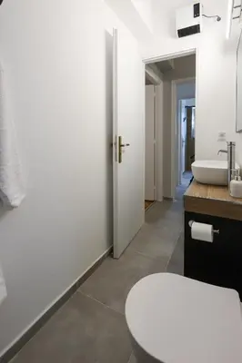 a bathroom with a toilet and a sink at Prime location Athens Exec 2BD Apt by Live&Travel in Athens