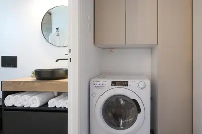 a laundry room with a washing machine in a kitchen at Prime location Athens Exec 2BD Apt by Live&Travel in Athens