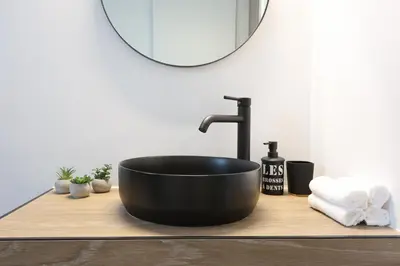 a black bath tub on a wooden counter in a bathroom at Prime location Athens Exec 2BD Apt by Live&Travel in Athens