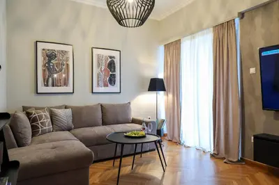 a living room with a couch and a table at Prime location Athens Exec 2BD Apt by Live&Travel in Athens