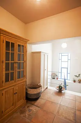 a room with a cabinet and a basket on the floor at Pagrati Hilton location Bentzi Family Suite 5 in Athens
