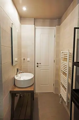 a bathroom with a sink and a white door at Pagrati Hilton location Bentzi Family Suite 5 in Athens
