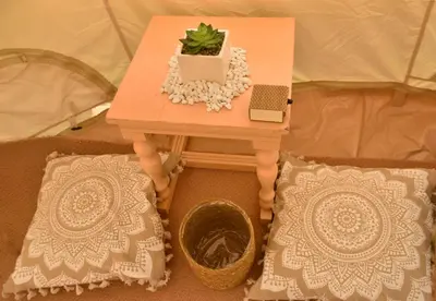 a small table with a plant and a laptop on it at Camping Tent Downtown & Garden Hanging Bed in Porto Rafti