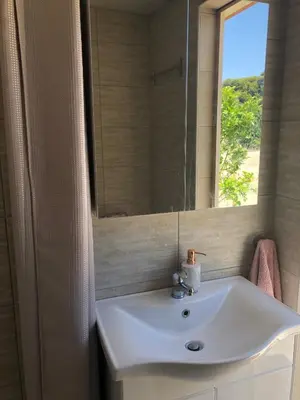 a bathroom with a sink and a mirror at Camping Tent Downtown & Garden Hanging Bed in Porto Rafti